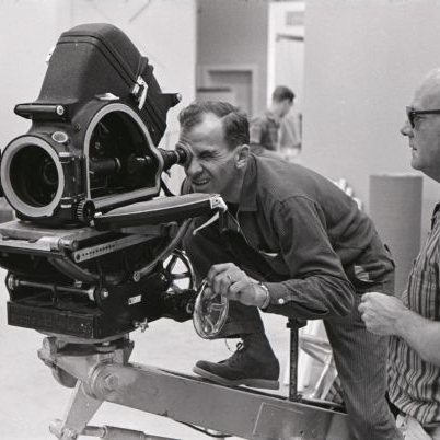 Two men working on a video camera